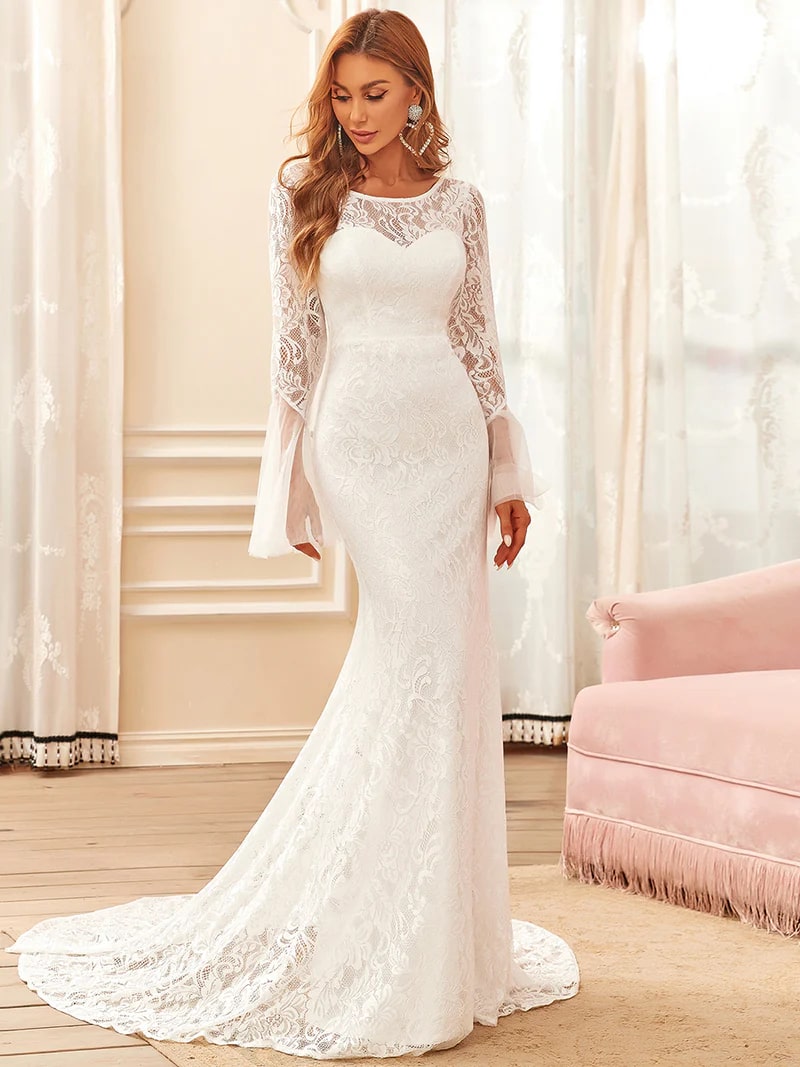 White wedding dress with round neck and long pagoda sleeves.